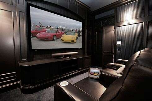 Домашний кинозал, чёрный интерьер с большим экраном